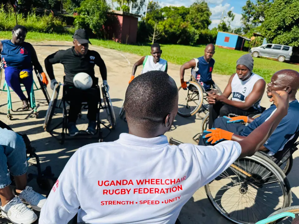 Wheelchair users gathered in a circle during a Gulu rugby session
