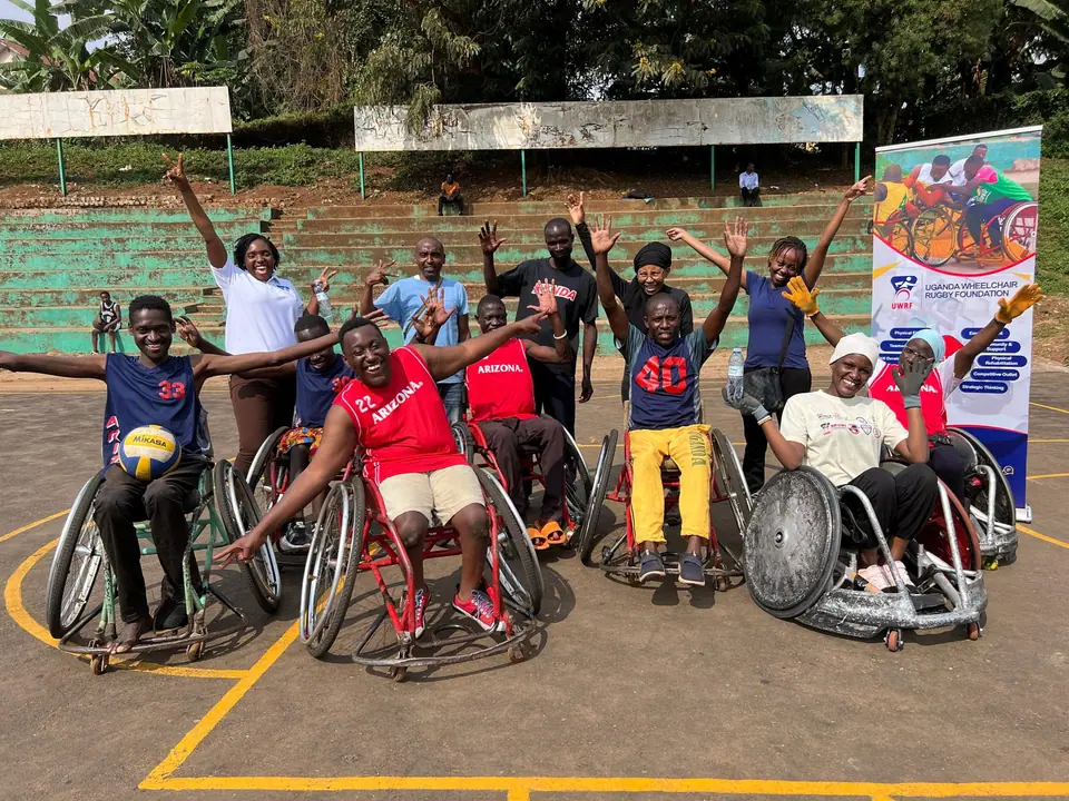 Uganda wheelchair rugby athletes and supporters celebrating together
