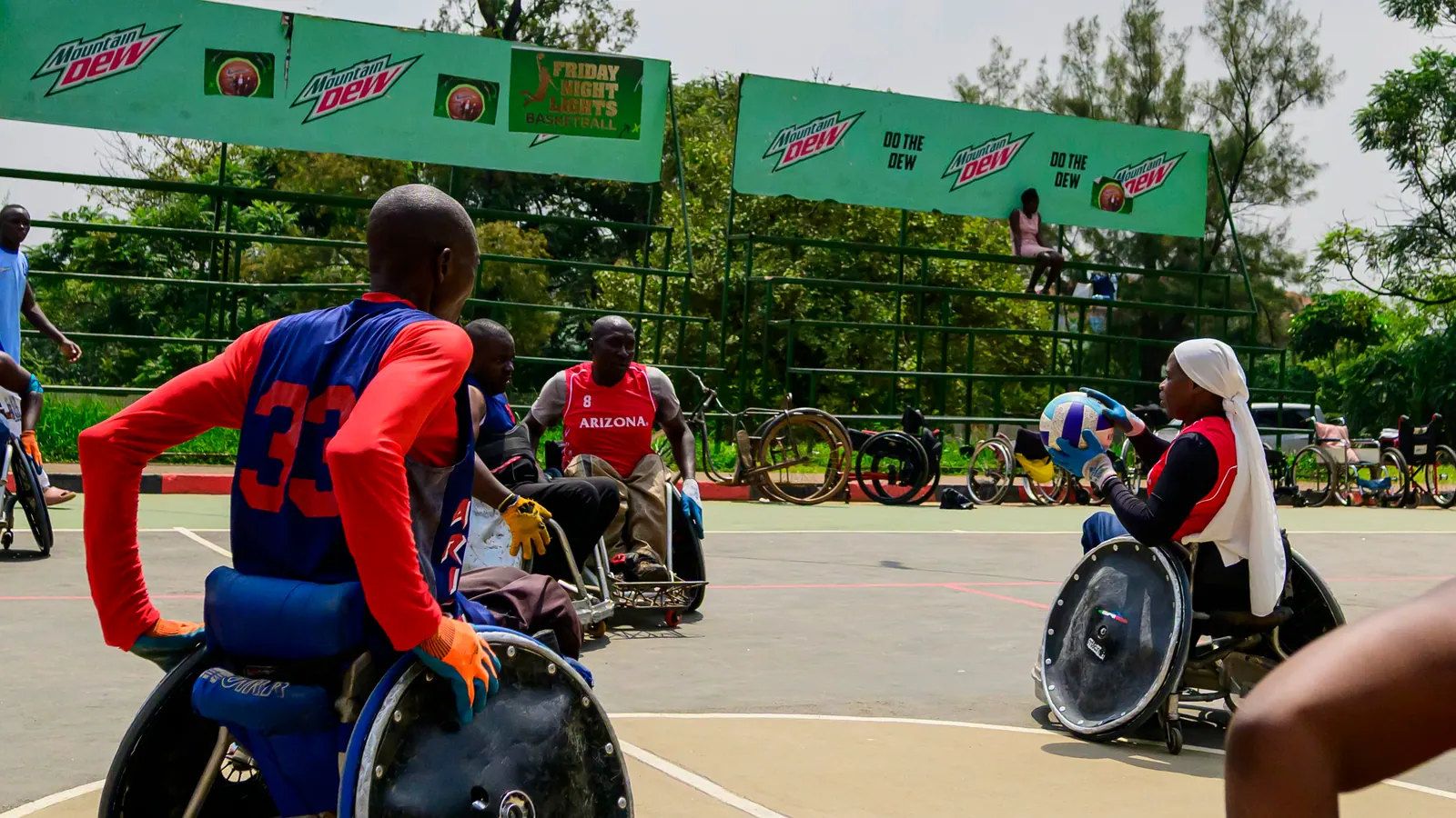Wheelchair rugby athletes positioned around the court