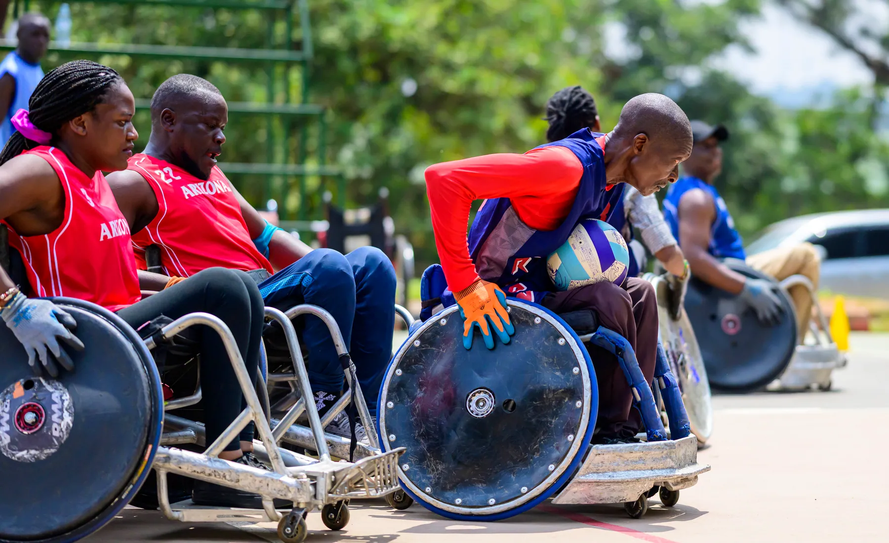 Uganda wheelchair rugby athletes preparing together on court