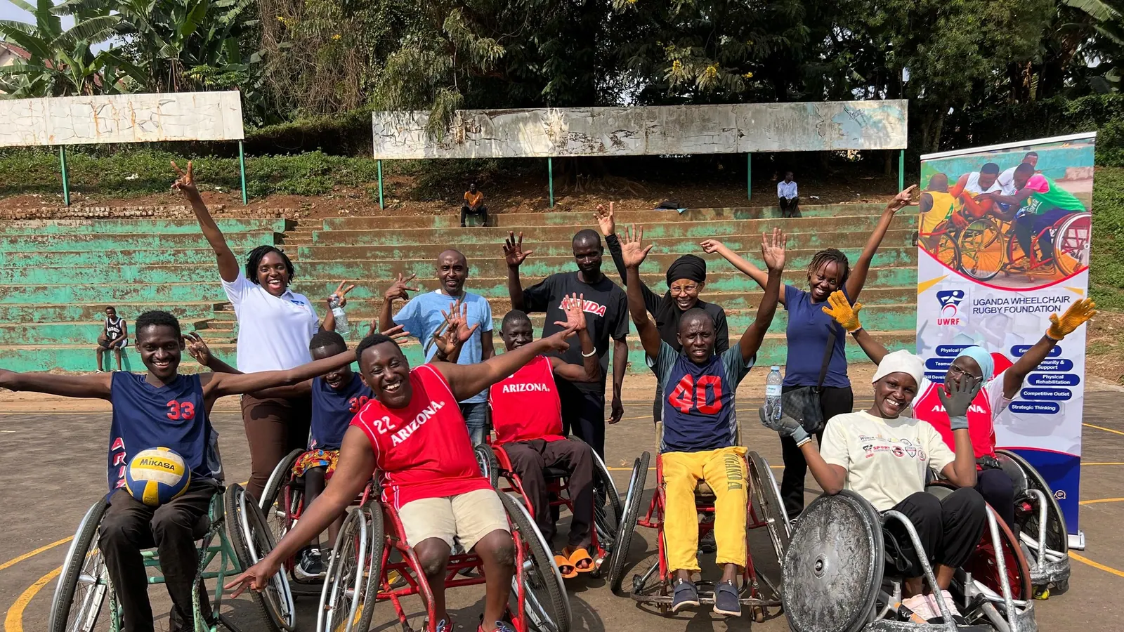 Wheelchair rugby participants celebrating together after training